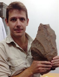 Dr James Cole with large Stone Age axe